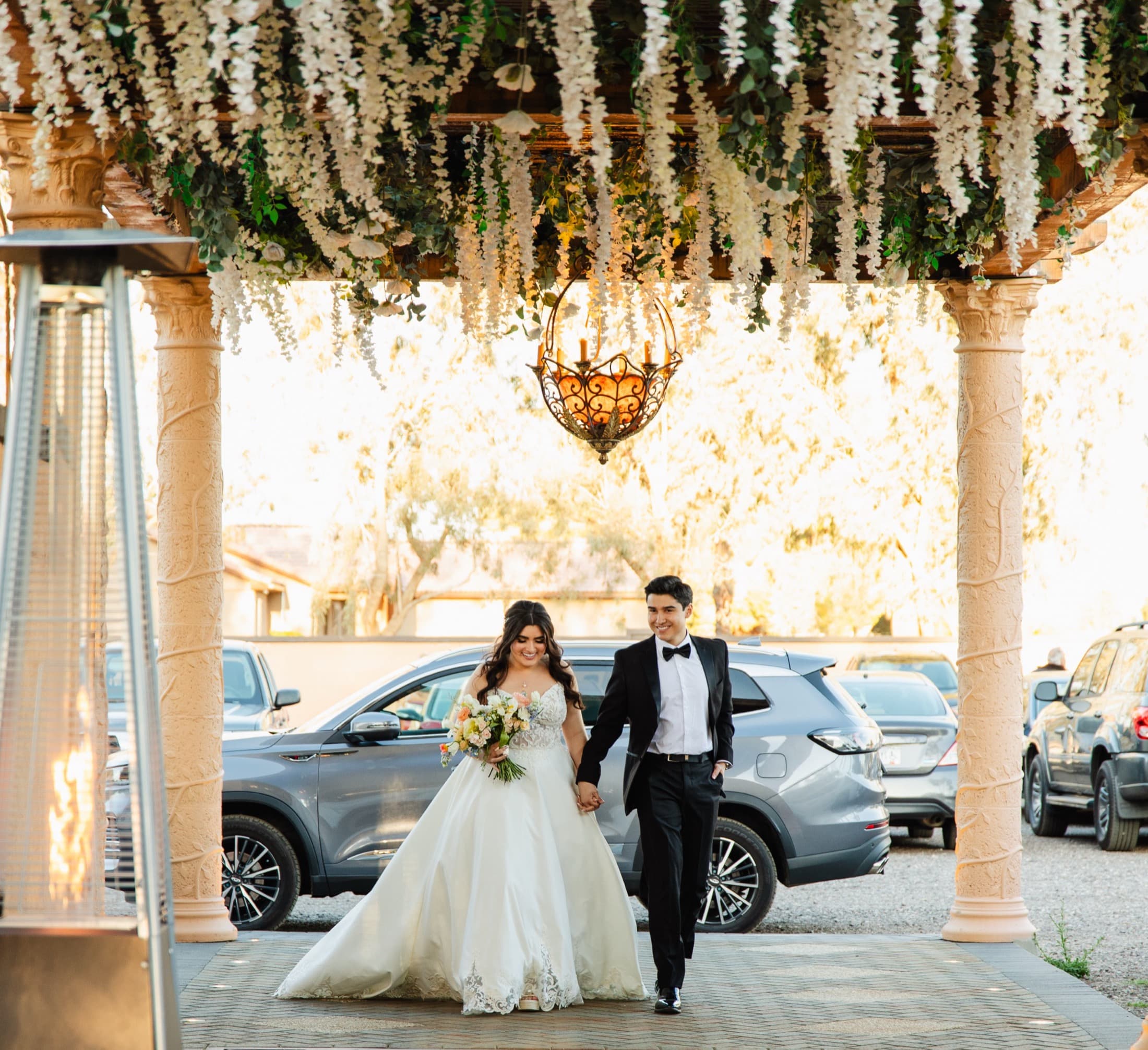 Bride and groom under the chandelier at Rancho Viejo Venue